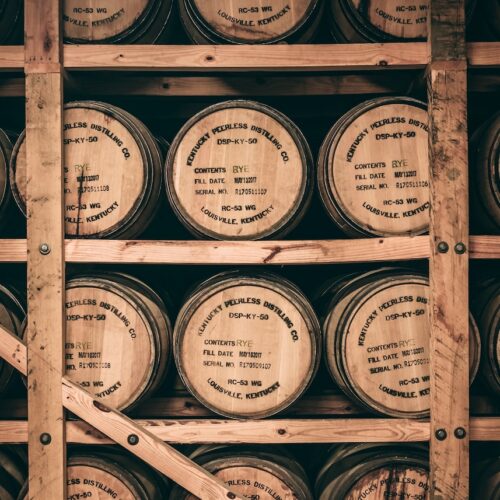 a shelf filled with lots of wooden barrels