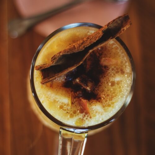 clear drinking glass with brown liquid