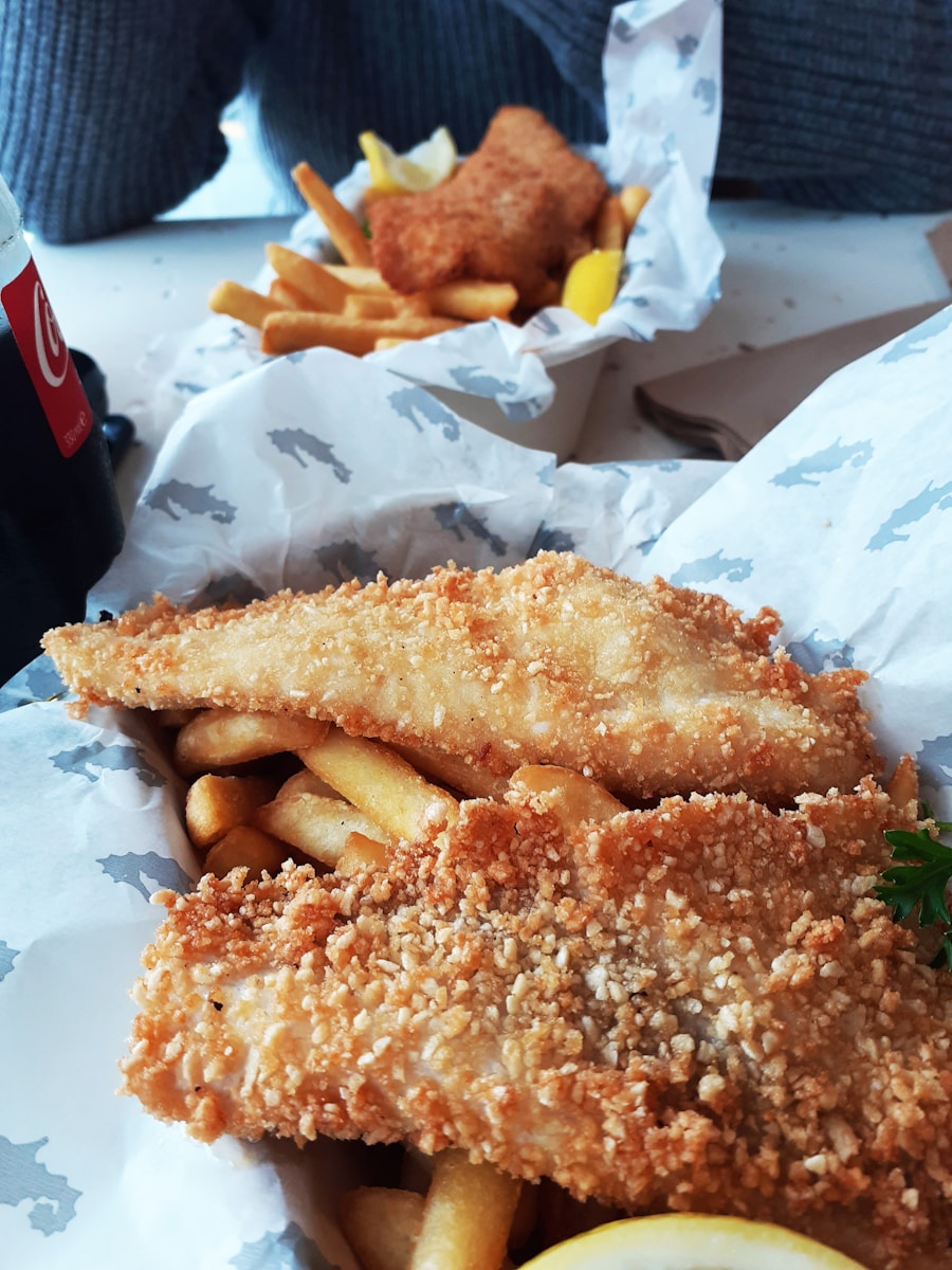 A fish and chips meal with a soda