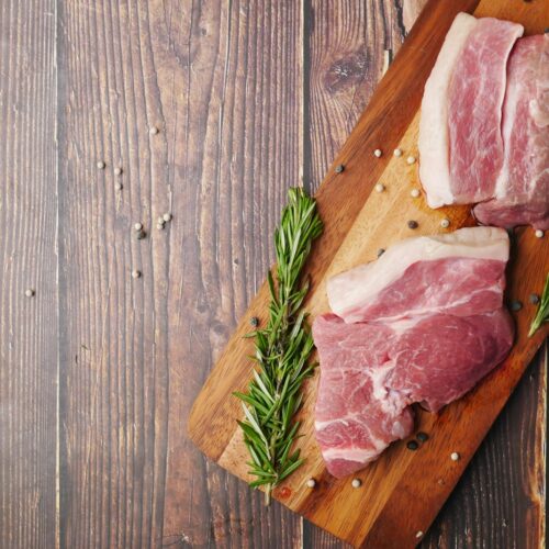 raw meat on brown wooden chopping board