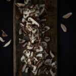 white and brown mushrooms on brown wooden table