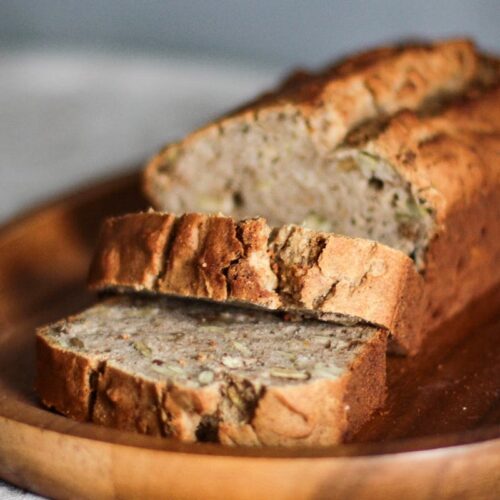 Close-up Photo of Sliced Brown Bread on Brown Wooden Tray