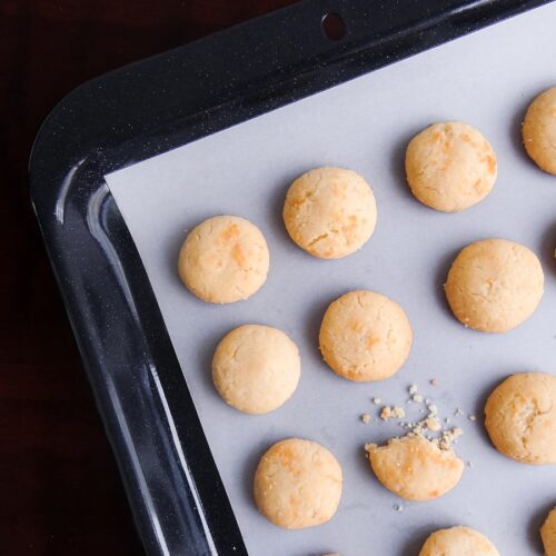 A pan filled with cookies on top of a wooden table