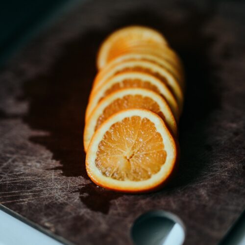 sliced lemon on brown wooden table