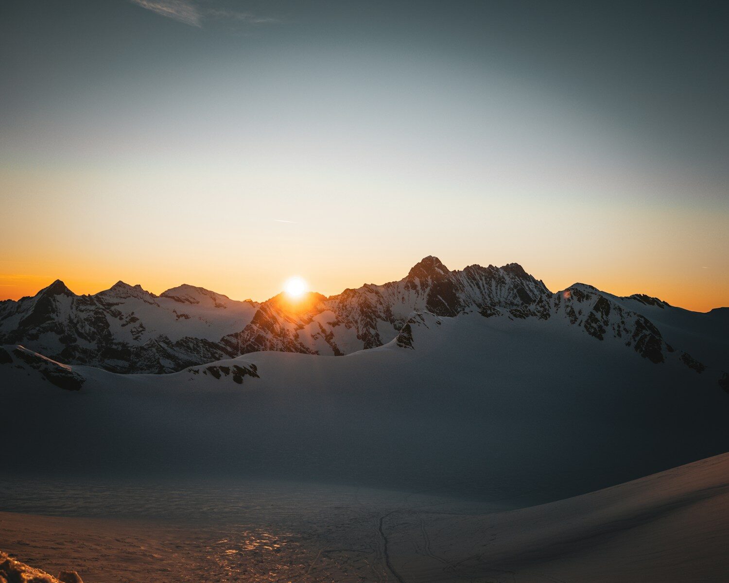 Sunrise over a snow-covered mountain range